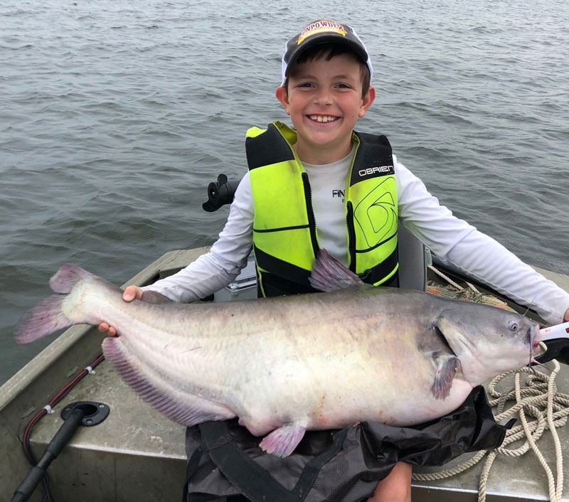 fishing kid with a huge catfish